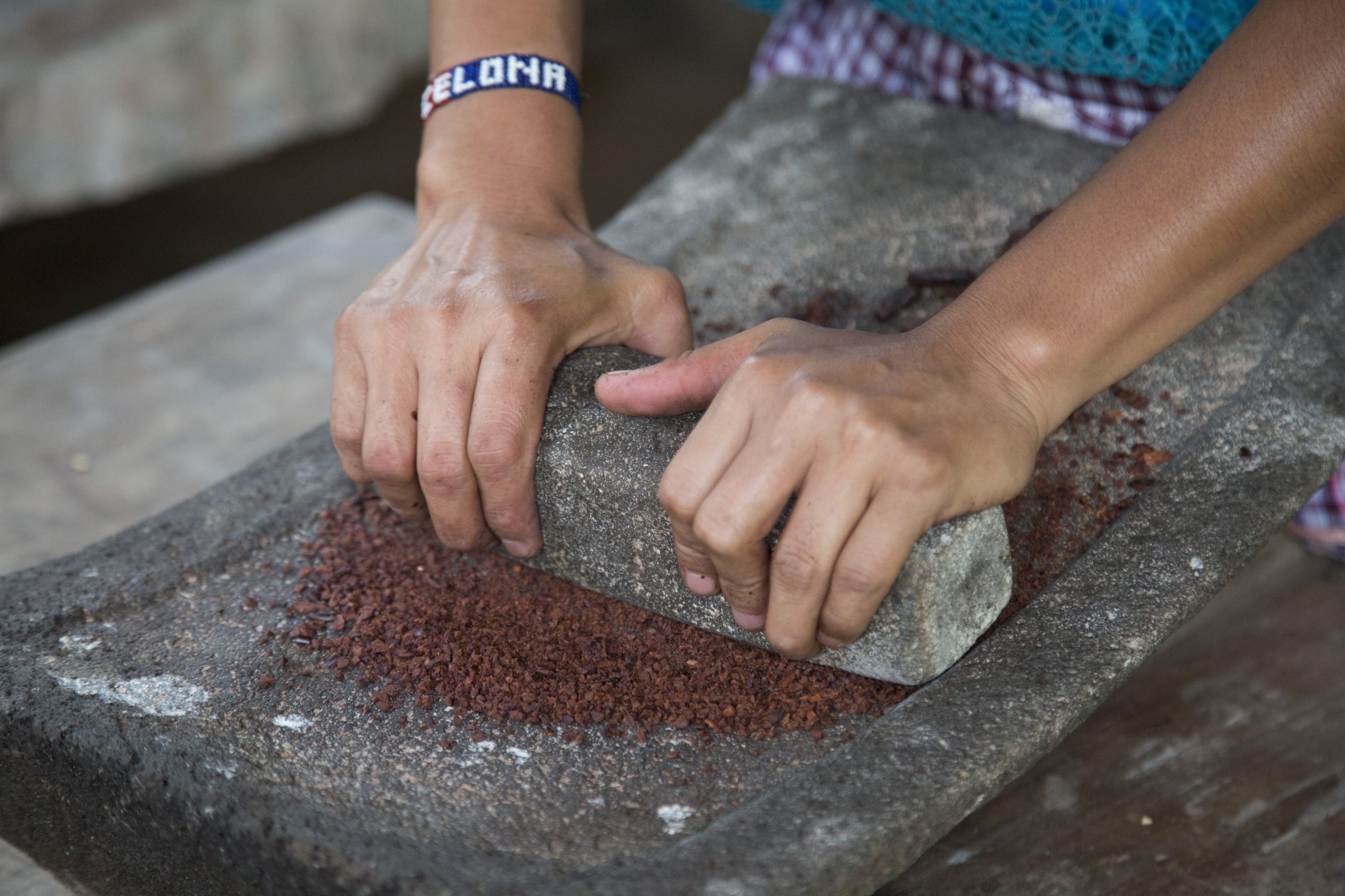 Cacao being ground in a stone mill